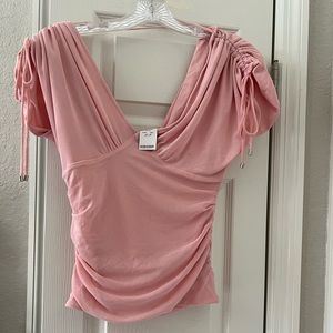 Bebe brand new with tags cute shirt with ties on the sleeves and ruched detail